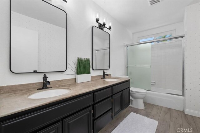 26532 Via Marina, Mission Viejo, CA 92691 - bathroom with double vanity, wood finished floors, and bath / shower combo with glass door