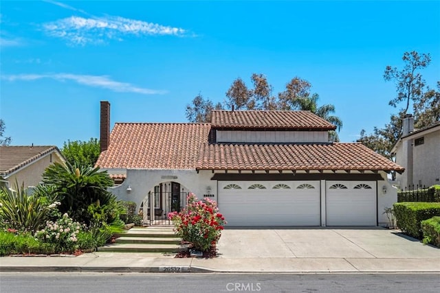 26532 Via Marina, Mission Viejo, CA 92691 - mediterranean / spanish-style house with a tiled roof, an attached garage, a chimney, driveway, and stucco siding