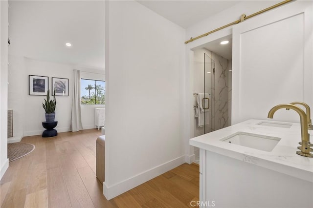 8396 Goldsport Cir, Huntington Beach, CA 92646 - full bathroom featuring a marble finish shower, wood finished floors, double vanity, and recessed lighting