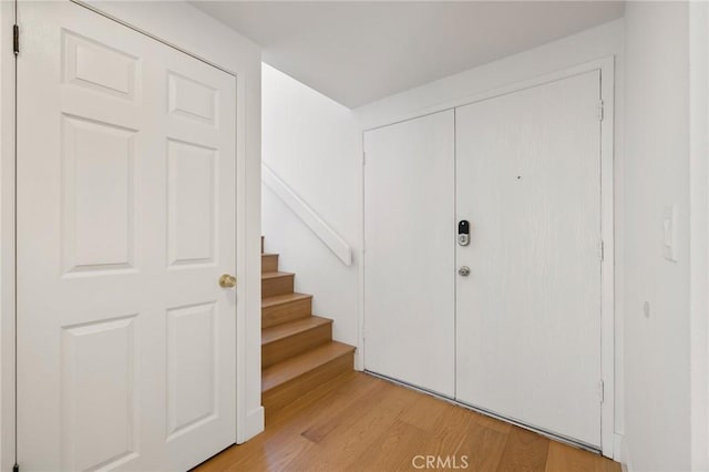 8396 Goldsport Cir, Huntington Beach, CA 92646 - entrance foyer with light wood finished floors and stairs