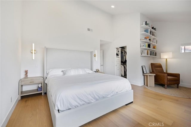 8396 Goldsport Cir, Huntington Beach, CA 92646 - bedroom with light wood-style floors, a spacious closet, and recessed lighting