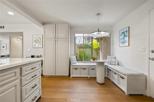 8396 Goldsport Cir, Huntington Beach, CA 92646 - kitchen with light countertops, light wood-style flooring, hanging light fixtures, white cabinetry, and recessed lighting