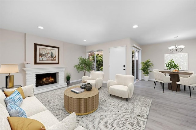 1304 Calle Grande Unit 68, Fullerton, CA 92835 - living area with a chandelier, light wood-style flooring, a brick fireplace, and recessed lighting