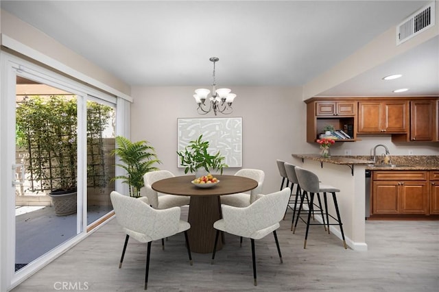 1304 Calle Grande Unit 68, Fullerton, CA 92835 - dining room with a chandelier and light wood finished floors