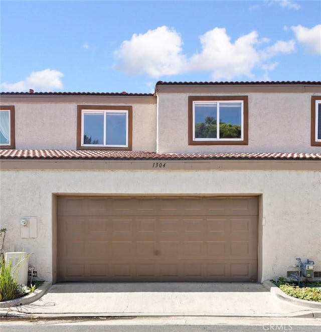 1304 Calle Grande Unit 68, Fullerton, CA 92835 - mediterranean / spanish-style house with stucco siding and a garage