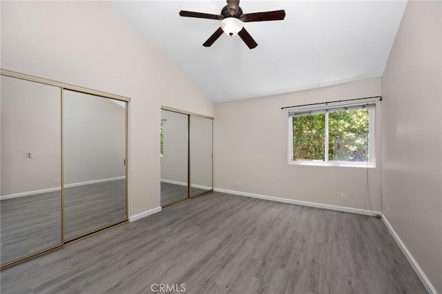 1304 Calle Grande Unit 68, Fullerton, CA 92835 - unfurnished bedroom featuring multiple closets, wood finished floors, high vaulted ceiling, and ceiling fan