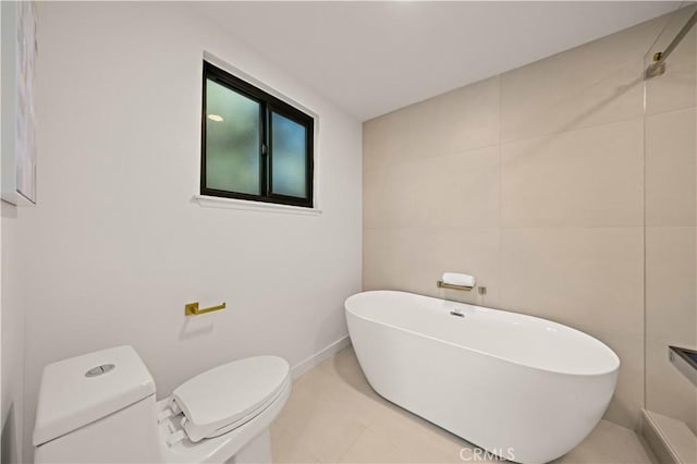 4700 Emerald Ave, La Verne, CA 91750 - bathroom featuring a freestanding tub, tile walls, and tile patterned floors