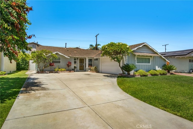 9099 Via Vista Dr, Buena Park, CA 90620 - ranch-style home with concrete driveway, a garage, a front yard, and board and batten siding
