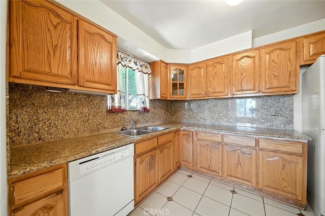 17229 Ardath Ave, Torrance, CA 90504 - kitchen with dishwasher, glass insert cabinets, light tile patterned floors, decorative backsplash, and brown cabinetry