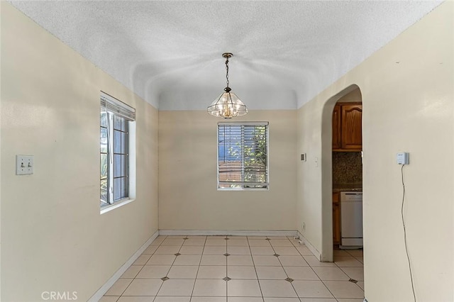 17229 Ardath Ave, Torrance, CA 90504 - unfurnished dining area featuring arched walkways, a chandelier, and a textured ceiling