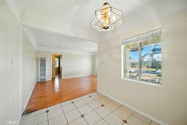 17229 Ardath Ave, Torrance, CA 90504 - unfurnished room with a heating unit, healthy amount of natural light, a chandelier, and light wood finished floors