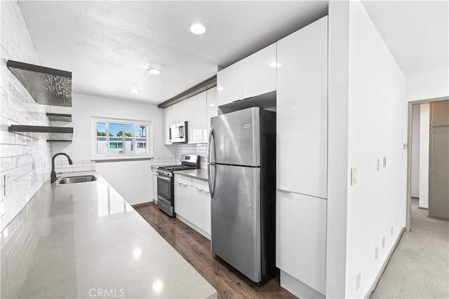 7135 Coldwater Canyon Ave Unit 16, North Hollywood, CA 91605 - kitchen with appliances with stainless steel finishes, open shelves, modern cabinets, white cabinetry, and tasteful backsplash