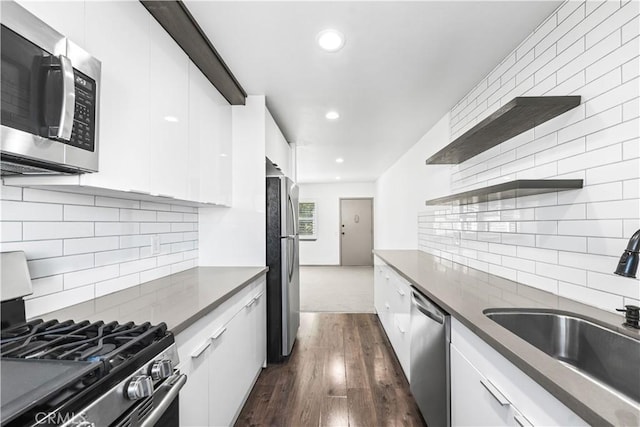 7135 Coldwater Canyon Ave Unit 16, North Hollywood, CA 91605 - kitchen with appliances with stainless steel finishes, modern cabinets, white cabinetry, dark wood-type flooring, and dark countertops