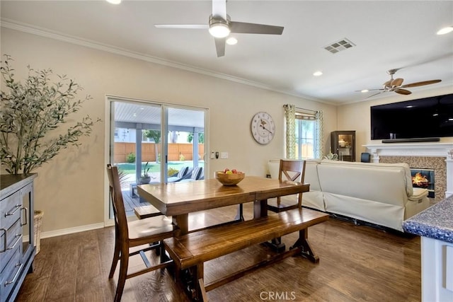 32839 Tiempo Cir, Temecula, CA 92592 - dining room with a ceiling fan, crown molding, dark wood finished floors, recessed lighting, and a glass covered fireplace