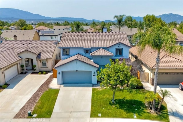 32839 Tiempo Cir, Temecula, CA 92592 - mediterranean / spanish-style house featuring concrete driveway, stucco siding, a mountain view, and a tiled roof