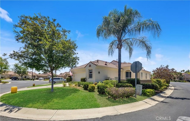 23681 Corte Sabio, Murrieta, CA 92562 - view of home's exterior with a garage, a lawn, a tile roof, stucco siding, and driveway