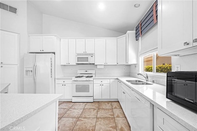 23681 Corte Sabio, Murrieta, CA 92562 - kitchen with white appliances, white cabinetry, light stone countertops, recessed lighting, and high vaulted ceiling