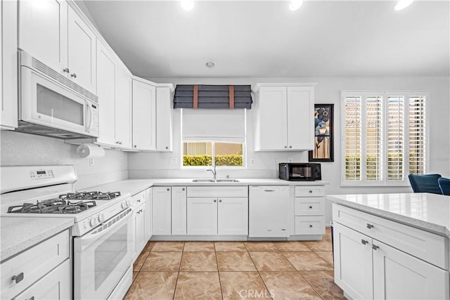 23681 Corte Sabio, Murrieta, CA 92562 - kitchen with white appliances, white cabinets, recessed lighting, and light tile patterned floors