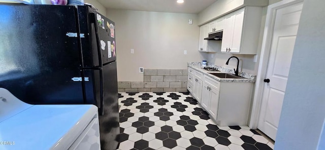 4141 Willow Trl, Frazier Park, CA 93225 - kitchen featuring freestanding refrigerator, white cabinetry, washer / dryer, under cabinet range hood, and light countertops