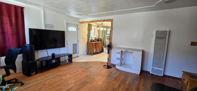 4141 Willow Trl, Frazier Park, CA 93225 - living room featuring a heating unit, wood finished floors, and a textured ceiling