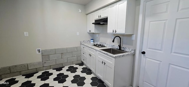 4141 Willow Trl, Frazier Park, CA 93225 - kitchen featuring under cabinet range hood, light countertops, white cabinets, and stainless steel gas stovetop