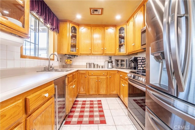 14724 Maclay St, San Fernando, CA 91345 - kitchen featuring stainless steel appliances, beverage cooler, light countertops, decorative backsplash, and recessed lighting