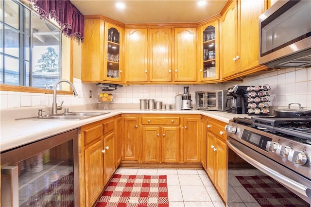 14724 Maclay St, San Fernando, CA 91345 - kitchen featuring stainless steel appliances, wine cooler, light countertops, and tasteful backsplash