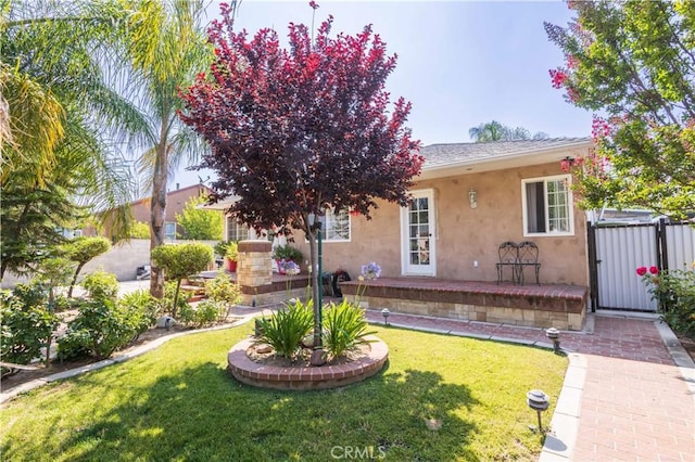 14724 Maclay St, San Fernando, CA 91345 - view of front facade featuring stucco siding, a front lawn, and a gate