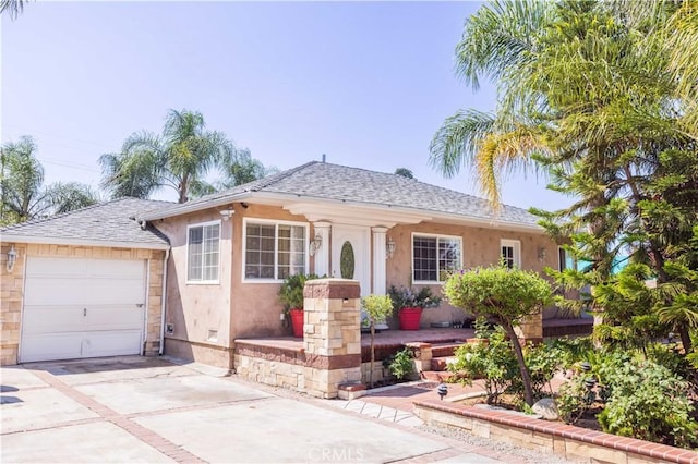 14724 Maclay St, San Fernando, CA 91345 - view of front of property with stucco siding, concrete driveway, roof with shingles, and a garage