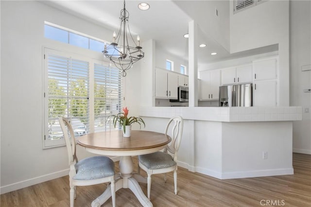 75 Shorebreaker Dr, Laguna Niguel, CA 92677 - dining space with a chandelier, light wood-type flooring, recessed lighting, and a towering ceiling