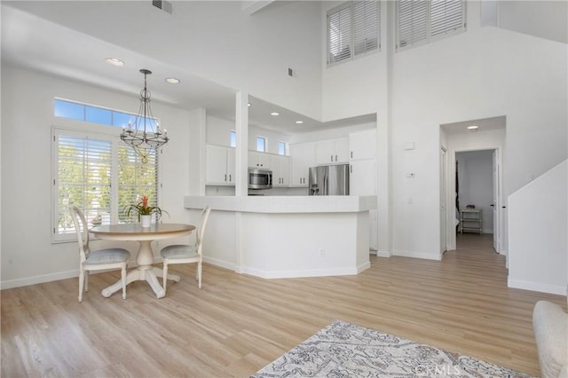 75 Shorebreaker Dr, Laguna Niguel, CA 92677 - kitchen with appliances with stainless steel finishes, light wood-type flooring, a chandelier, white cabinetry, and light countertops