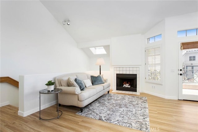 75 Shorebreaker Dr, Laguna Niguel, CA 92677 - living room featuring wood finished floors, a skylight, a tile fireplace, and high vaulted ceiling