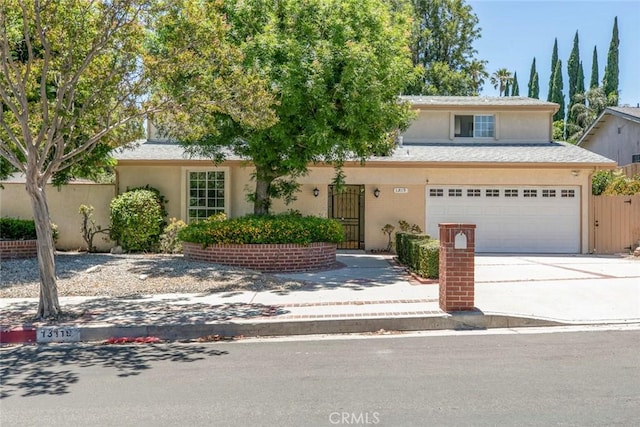 13119 Constable Ave, Granada Hills, CA 91344 - view of front of property with concrete driveway, stucco siding, and a garage