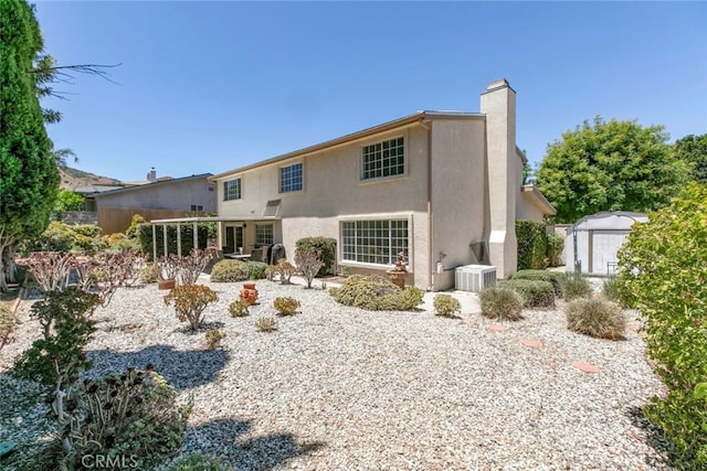 13119 Constable Ave, Granada Hills, CA 91344 - back of property with a storage unit, a chimney, and stucco siding