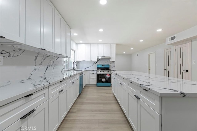 13119 Constable Ave, Granada Hills, CA 91344 - kitchen with appliances with stainless steel finishes, a kitchen island, backsplash, white cabinets, and recessed lighting