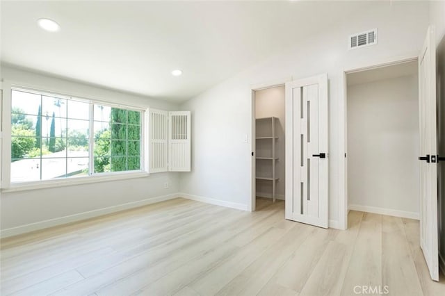 13119 Constable Ave, Granada Hills, CA 91344 - unfurnished bedroom featuring light wood-style flooring, vaulted ceiling, a spacious closet, and recessed lighting