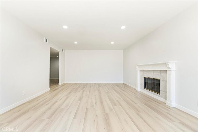 13119 Constable Ave, Granada Hills, CA 91344 - unfurnished living room with light wood-style floors, a tiled fireplace, and recessed lighting