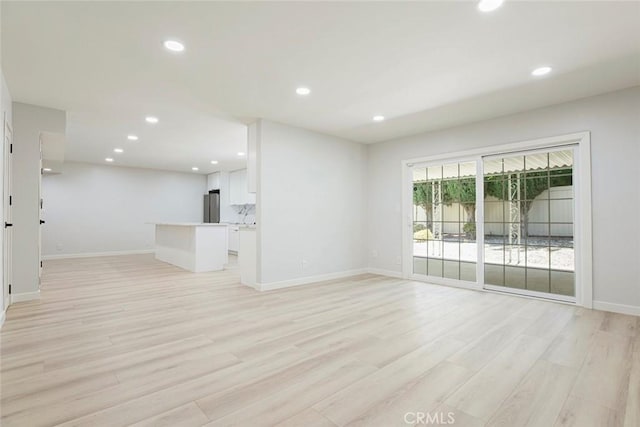 13119 Constable Ave, Granada Hills, CA 91344 - unfurnished living room featuring light wood finished floors and recessed lighting