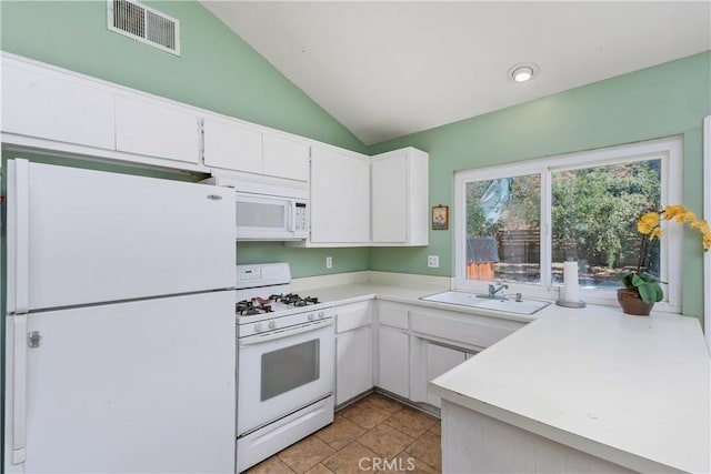 5080 Pearblossom, Riverside, CA 92507 - kitchen featuring white appliances, vaulted ceiling, light countertops, and white cabinets