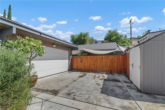 5080 Pearblossom, Riverside, CA 92507 - view of patio / terrace featuring driveway and an attached garage