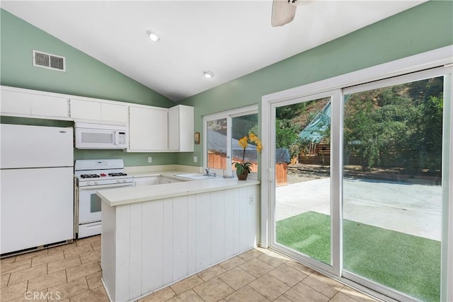 5080 Pearblossom, Riverside, CA 92507 - kitchen with white appliances, lofted ceiling, light countertops, white cabinets, and a peninsula