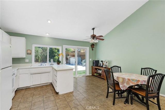 5080 Pearblossom, Riverside, CA 92507 - kitchen with light countertops, freestanding refrigerator, ceiling fan, a peninsula, and white cabinets