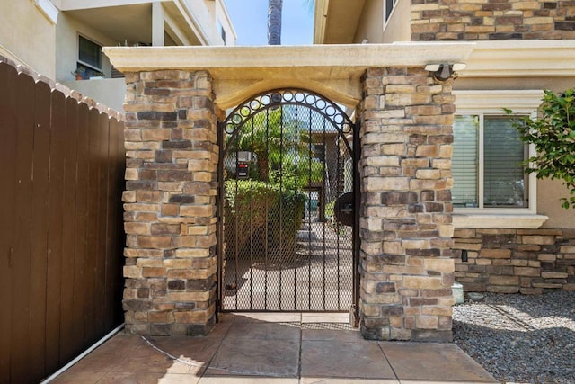 1361 Felspar St Unit 7, San Diego, CA 92109 - view of exterior entry featuring a gate and stone siding
