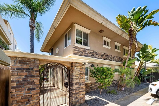 1361 Felspar St Unit 7, San Diego, CA 92109 - view of front facade featuring stucco siding and a gate