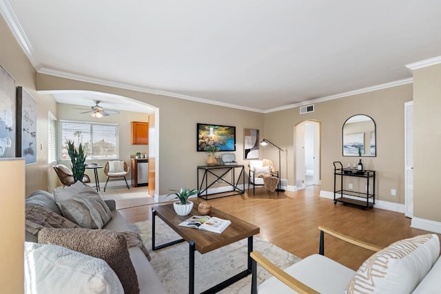 1361 Felspar St Unit 7, San Diego, CA 92109 - living area featuring arched walkways, a ceiling fan, crown molding, and light wood-style floors