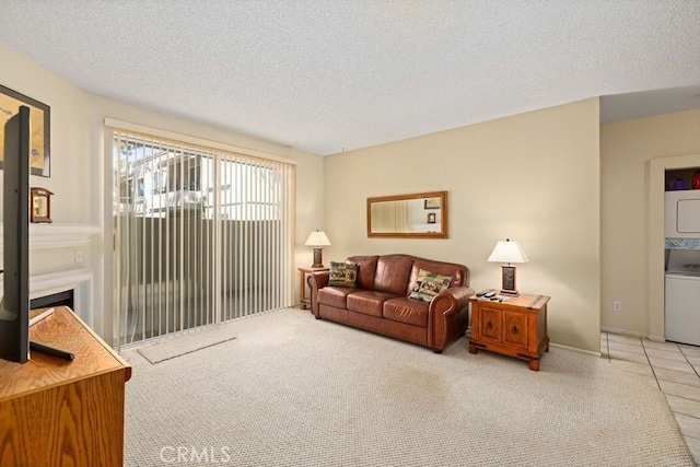 2823 W W Ave K12, Unit 136, Lancaster, CA 93536 - carpeted living room featuring stacked washing machine and dryer and a textured ceiling