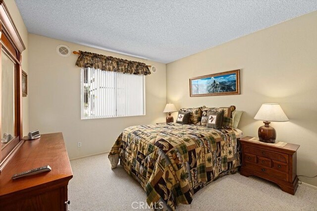 2823 W W Ave K12, Unit 136, Lancaster, CA 93536 - bedroom featuring light colored carpet and a textured ceiling