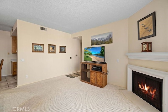 2823 W W Ave K12, Unit 136, Lancaster, CA 93536 - living room featuring carpet floors, a fireplace with flush hearth, and a textured ceiling