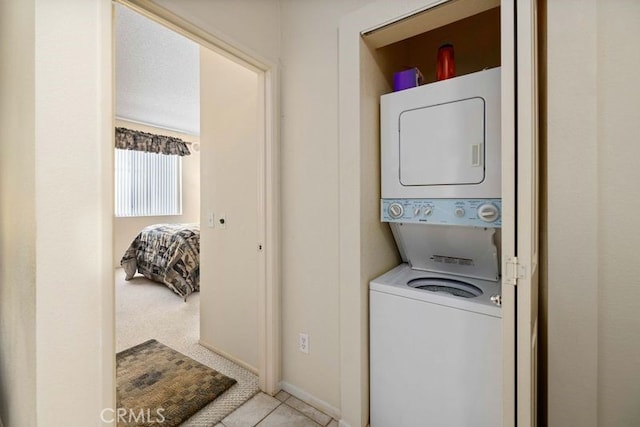 2823 W W Ave K12, Unit 136, Lancaster, CA 93536 - washroom featuring stacked washer and clothes dryer and tile patterned flooring