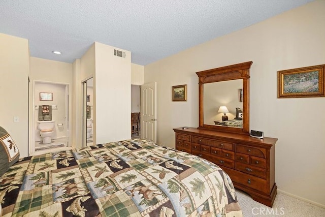 2823 W W Ave K12, Unit 136, Lancaster, CA 93536 - carpeted bedroom featuring a textured ceiling and ensuite bathroom